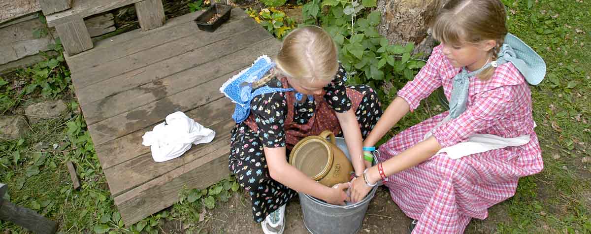 Two girls in period costumes