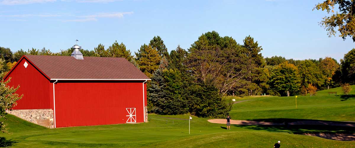 Golf course and red barn