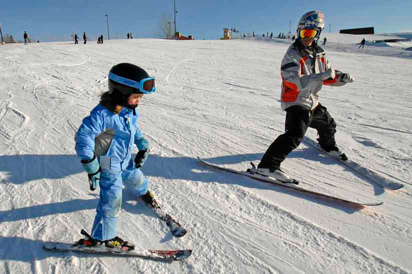 Child and instructor on ski hill