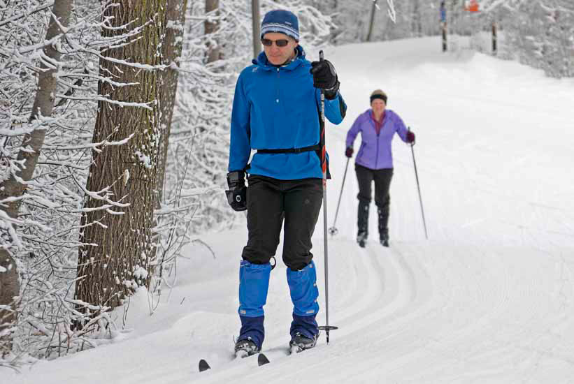 Skiers on a groomed trail