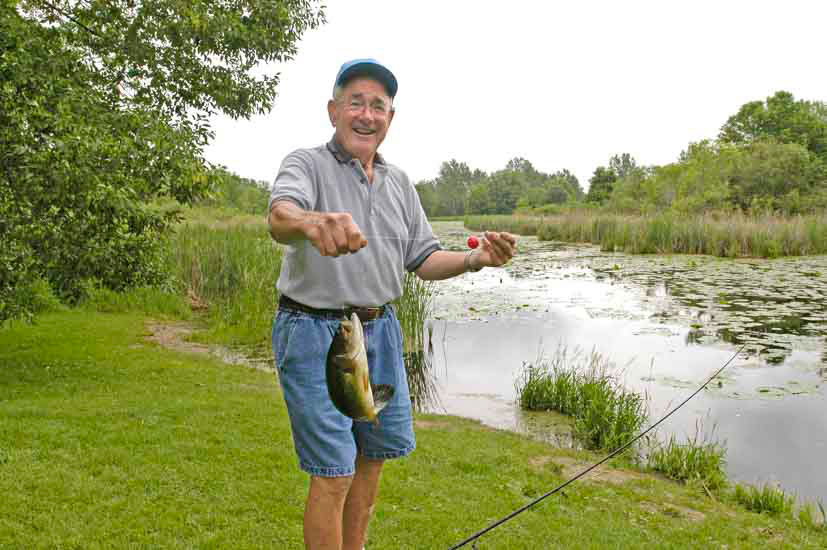 Man showing of the fish he caught