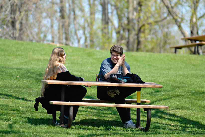 Couple enjoying picnic on a hillside
