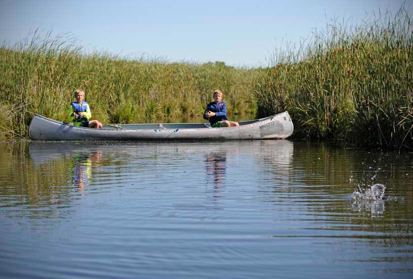 Boys in a canoe fishing
