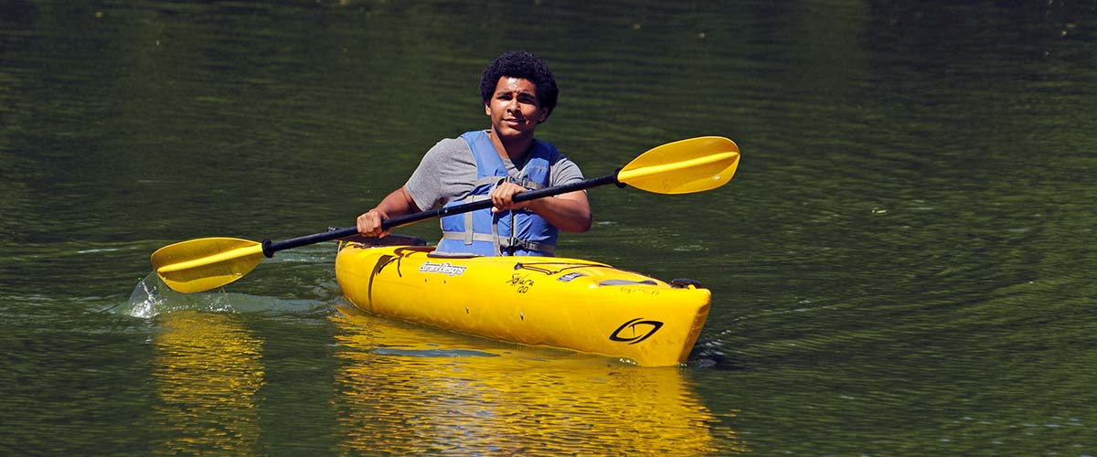Boy paddling a kayak