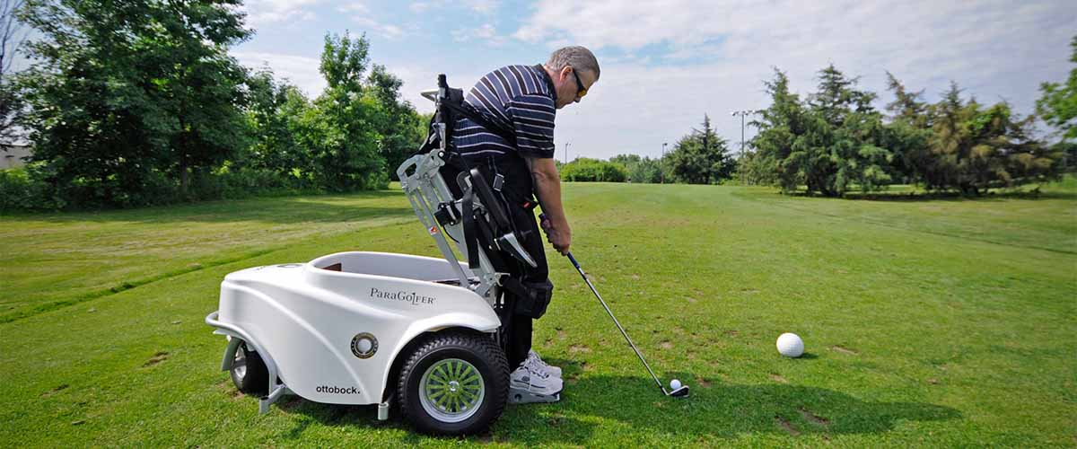 Golfer preparing to drive ball from accessible cart