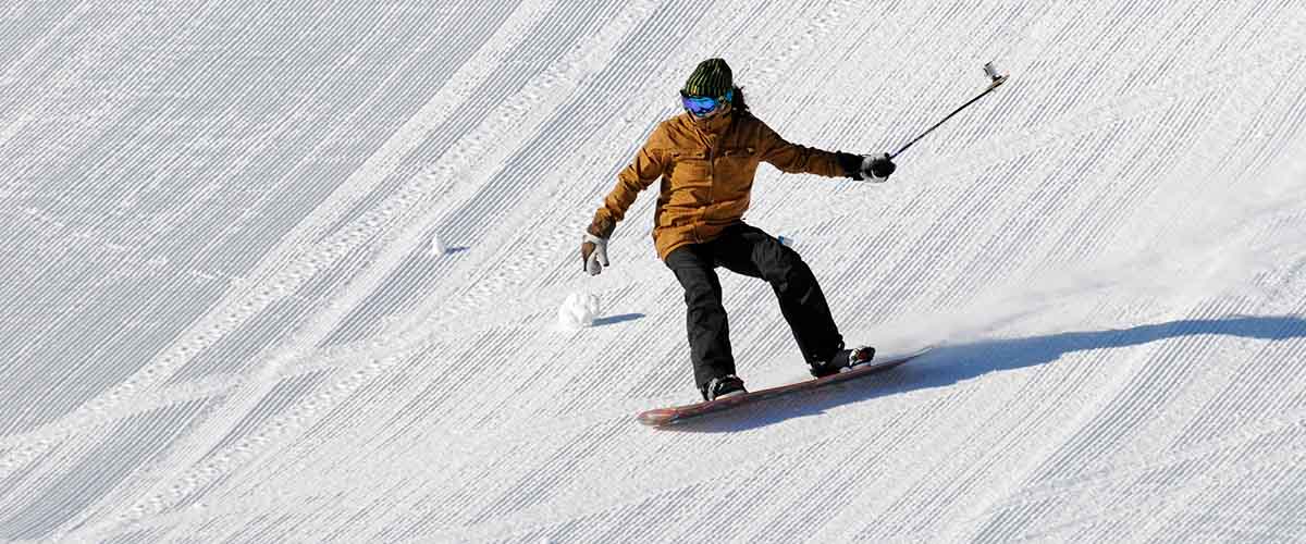Snowboarder on freshly groomed hill