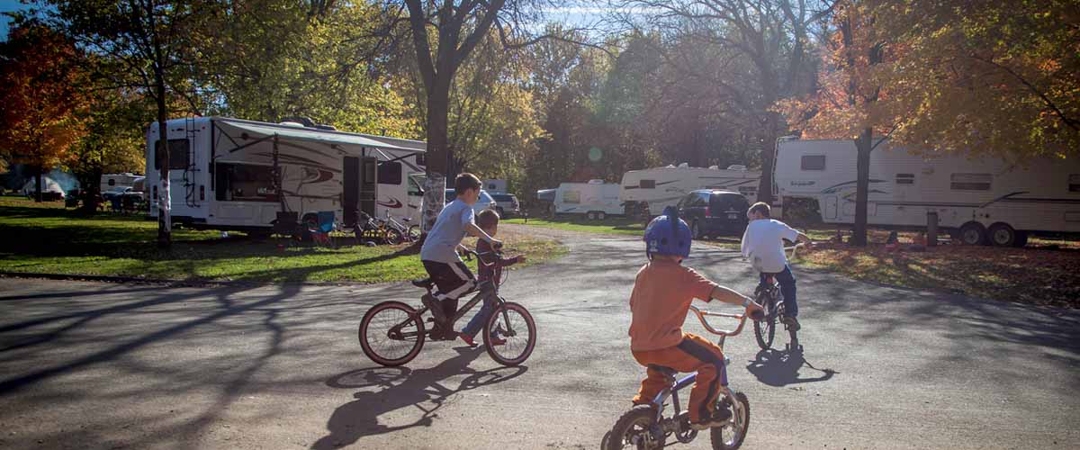 children riding bicycles in campground