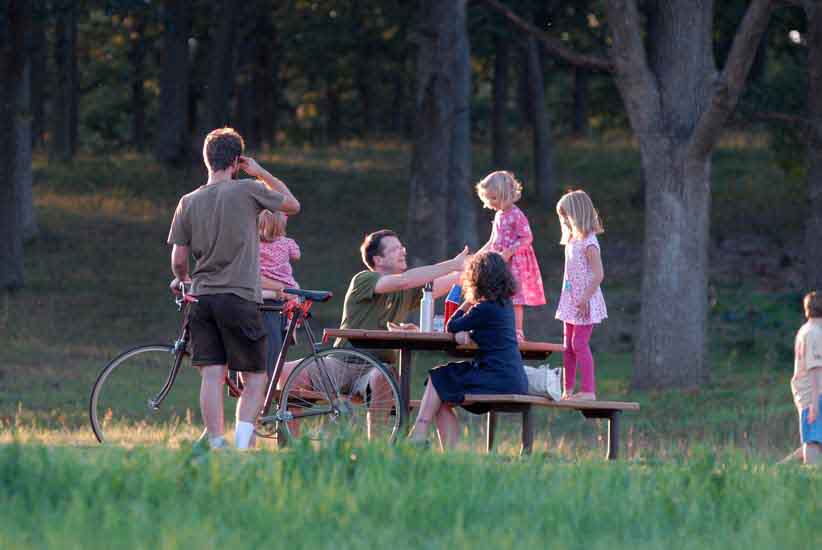 A family gathers around a picnic table