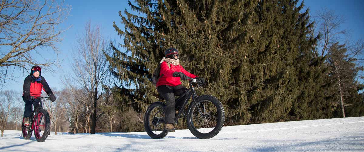 two people riding fat bikes in the winter