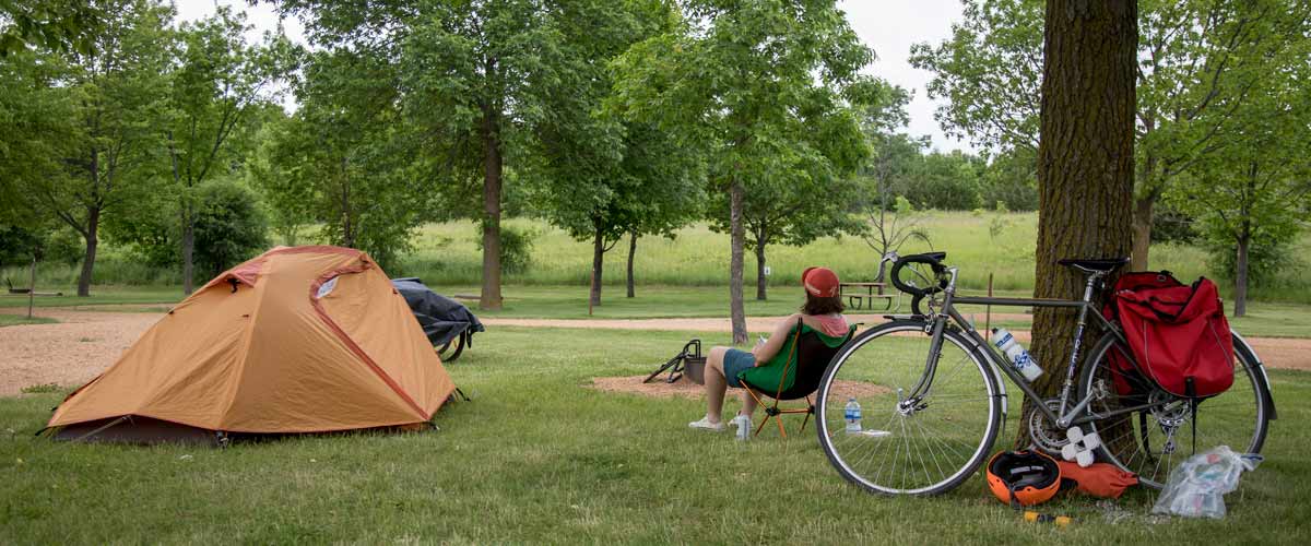 a campsite with a tent and a bike.