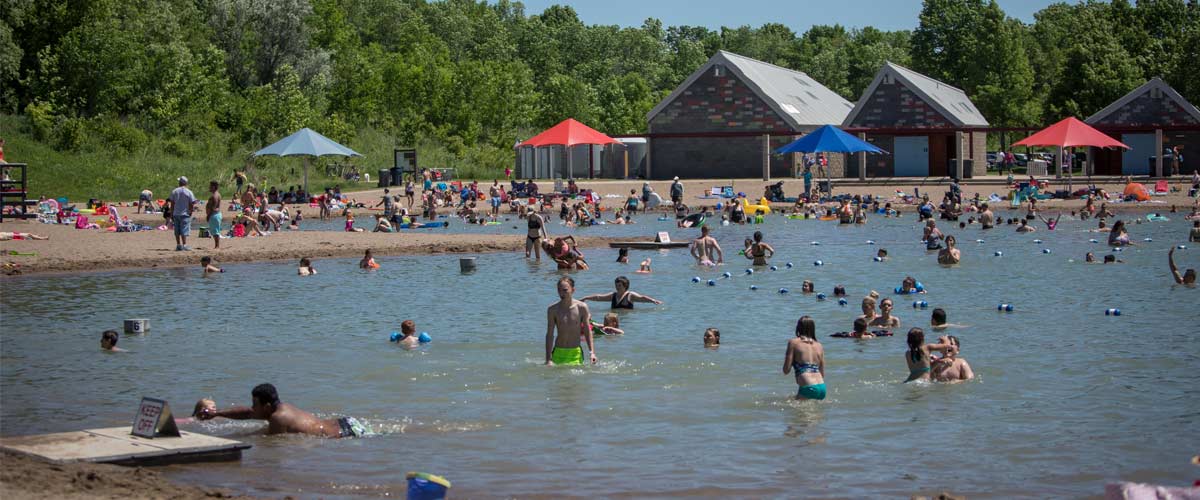 People in the water at the elm creek swim pond