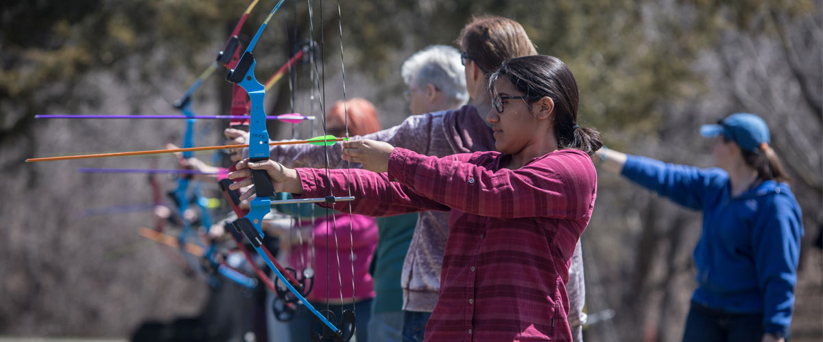 women aiming arrows