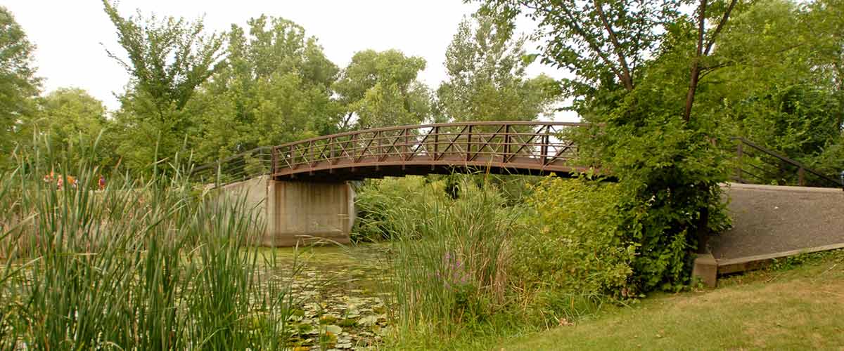 A bridge over a stream in french regional park.