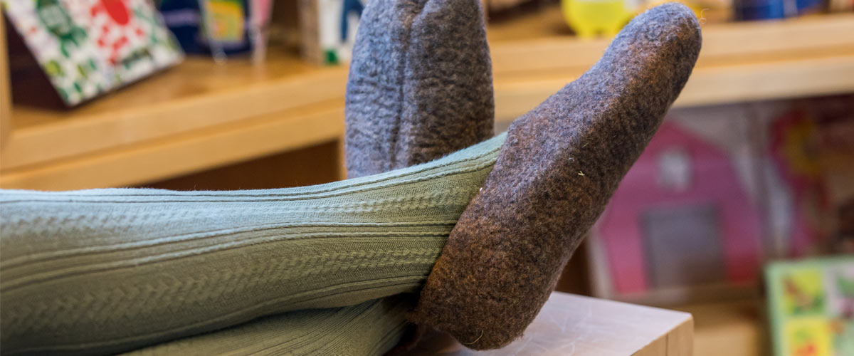 feet wearing purple wool slippers