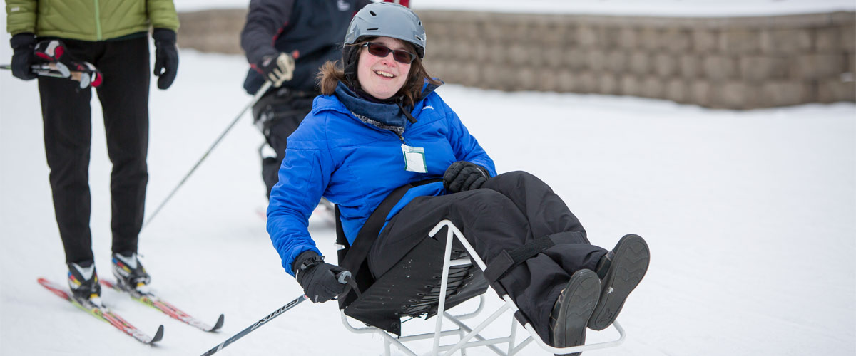 a woman in an adapted sit-ski