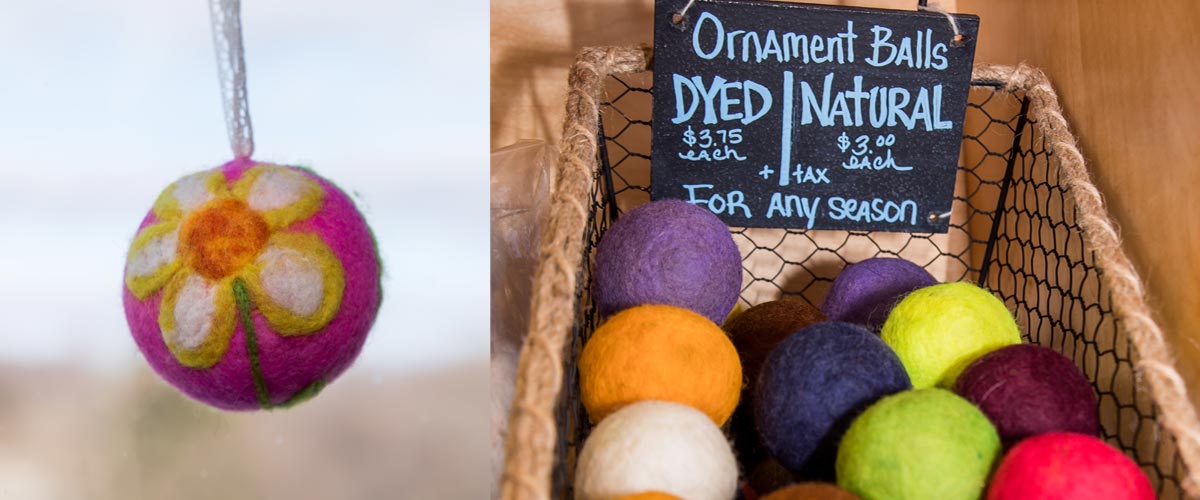 colorful felted ball ornaments in a wicker basket. On the left side is a close-up image of an ornament that is purple with a white flower on it. 