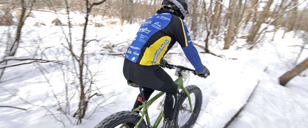 a mountain biker on a snowy trail.