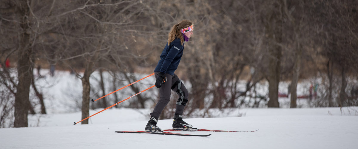 A woman cross-country skis. 