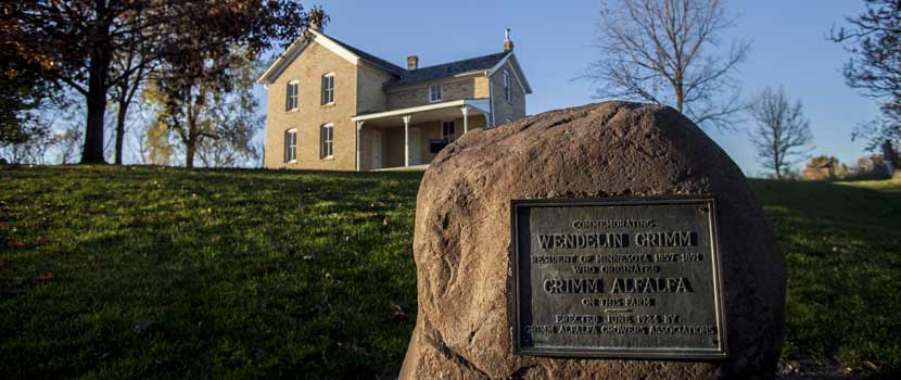 a monument to wendelin grimm in front of the grimm farmhouse.