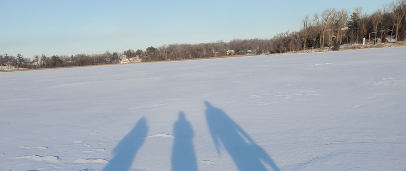 Three shadows stretch out on the snow on Bush Lake.