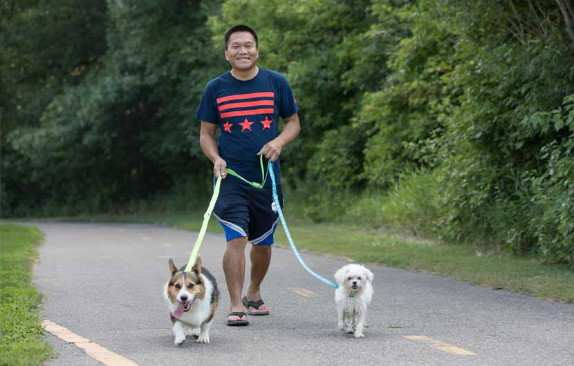 man walking two dogs