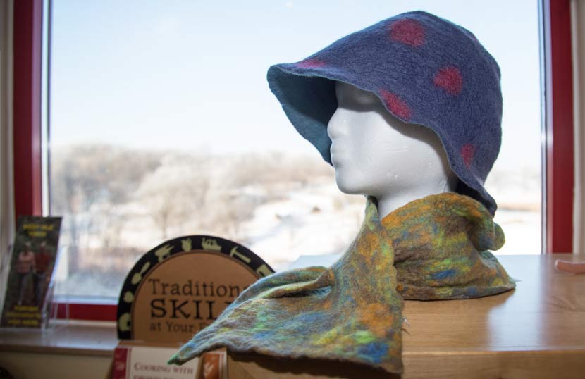 mannequin head sporting a felt hat and felt scarf