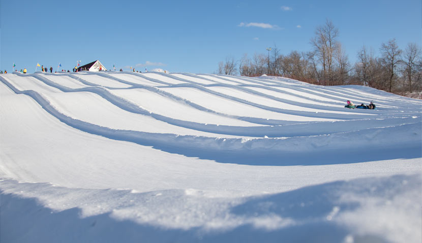 snow divided lanes of the tubing hill