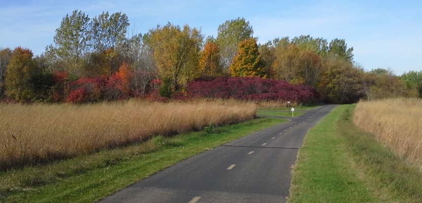 paved trail through colorful autumn prairies 