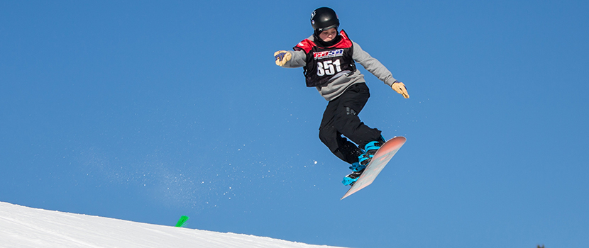 A boy competes in a snowboard competition