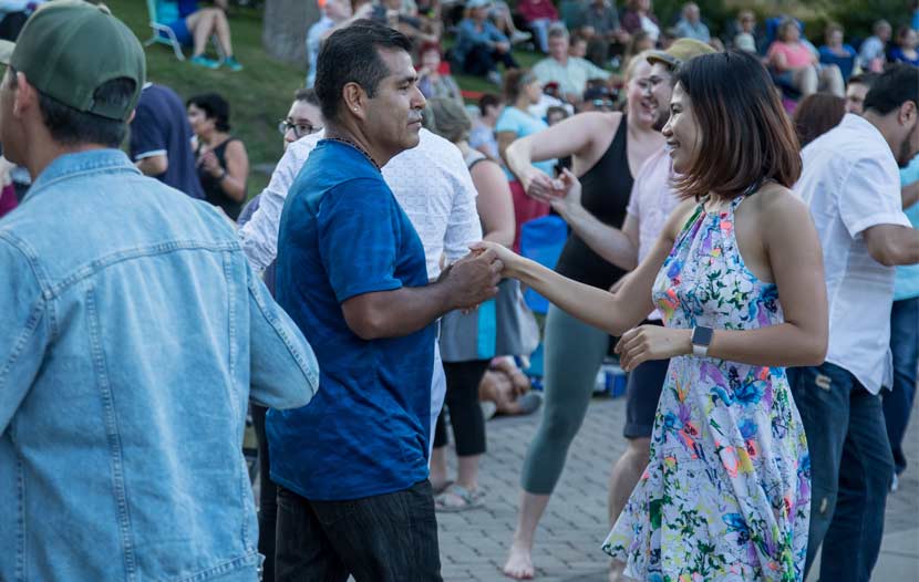 A couple dances to live music at Silverwood Park. 