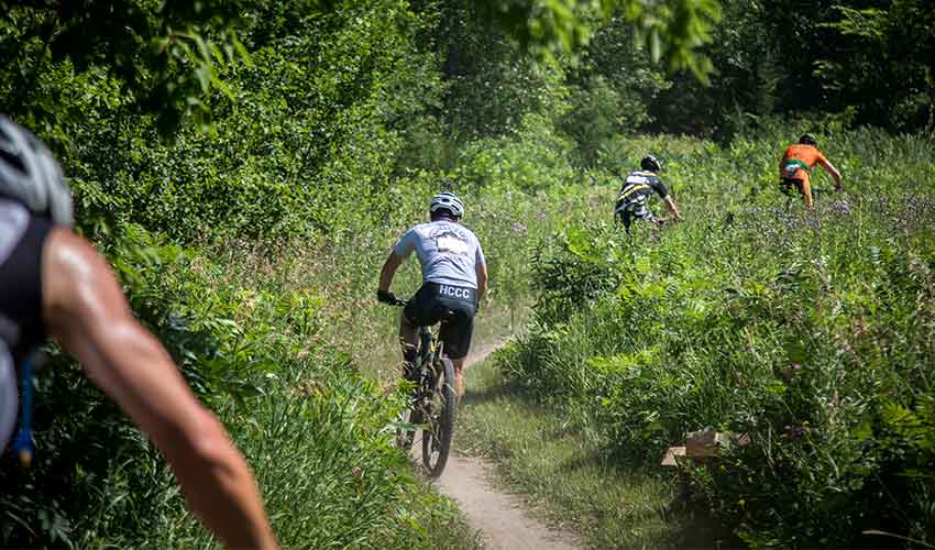mountain bikers on the singletrack trail winding through woods at lake rebecca